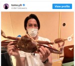 豪快にカニを持って笑顔を見せる山下智久　※「山下智久」インスタグラム