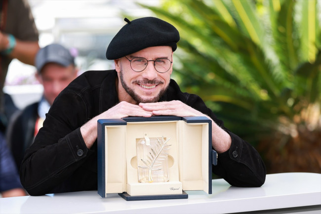 フォトコールで名誉パルムドールのトロフィーを披露するジョン・トラヴォルタ